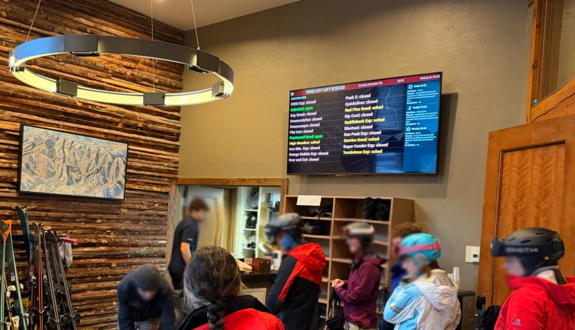 Hotel boot room display showing real-time mountain data